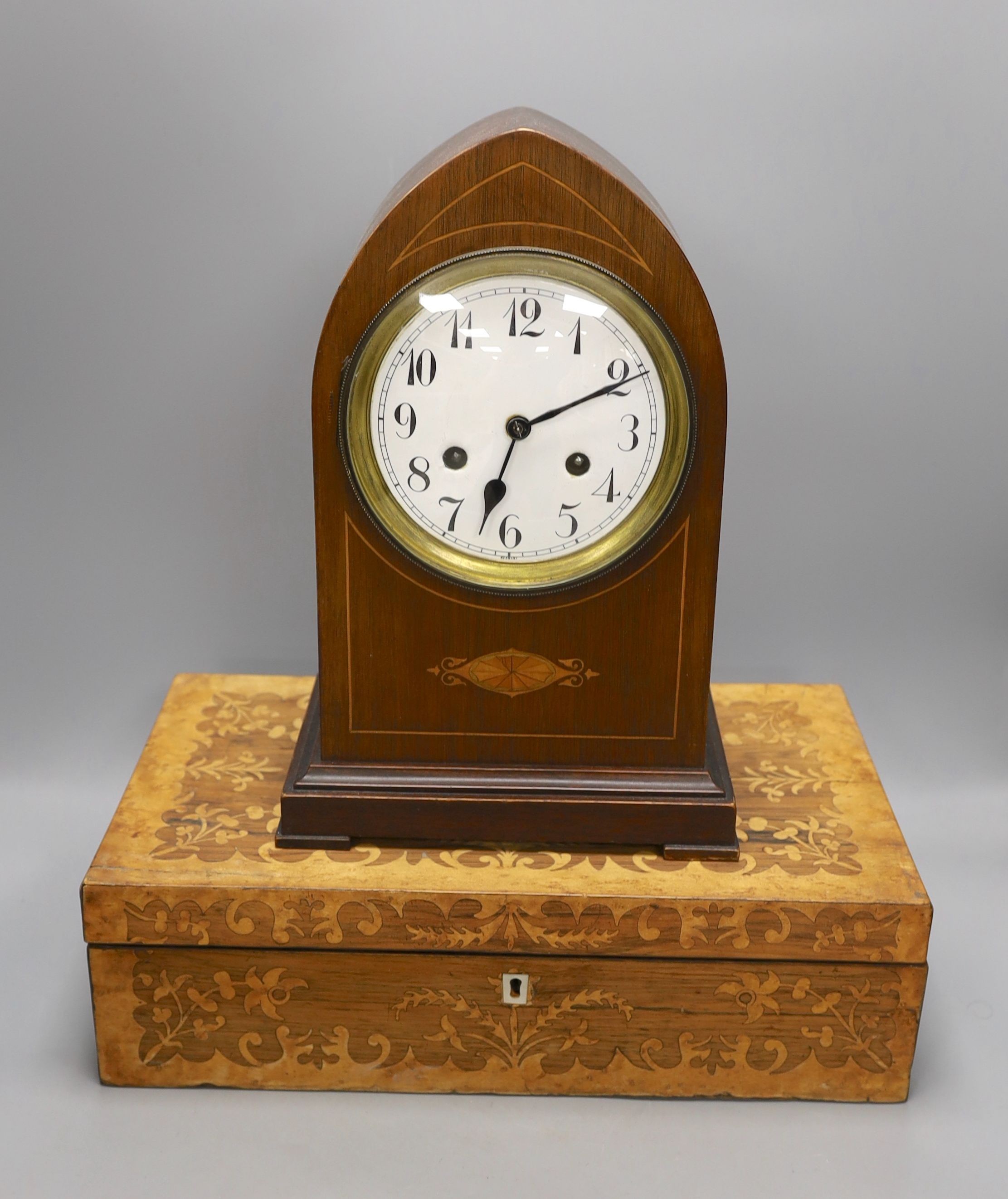 An early 20th century inlaid mahogany lancet shaped mantel clock and a Victorian rosewood and marquetry writing slope, writing slope, 41 cms wide x 12 cms high.